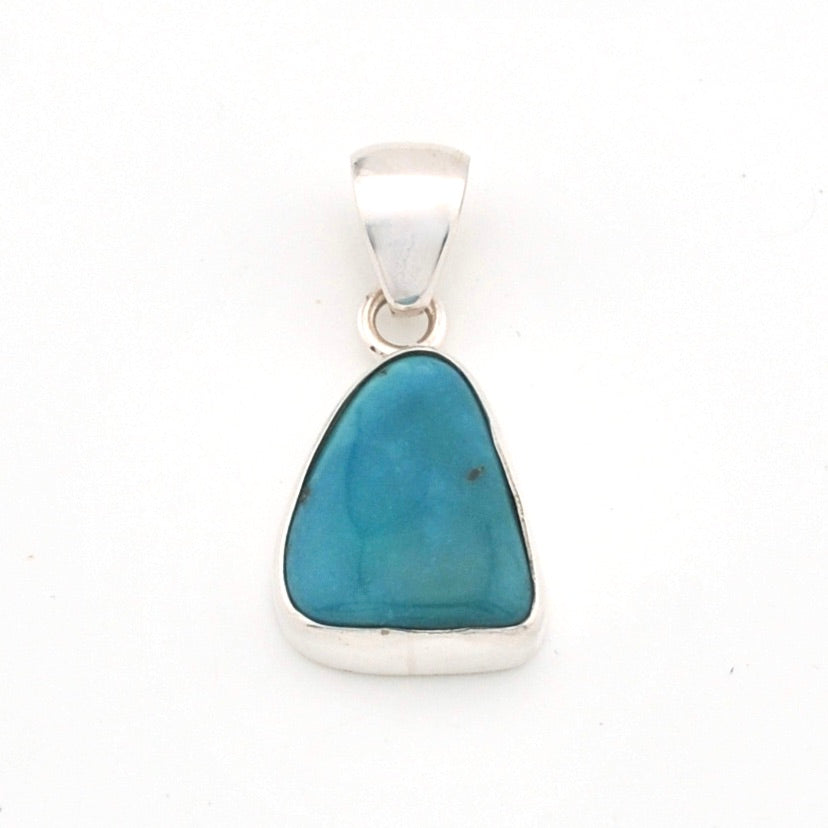 Turquoise pendant with silver setting on a white background