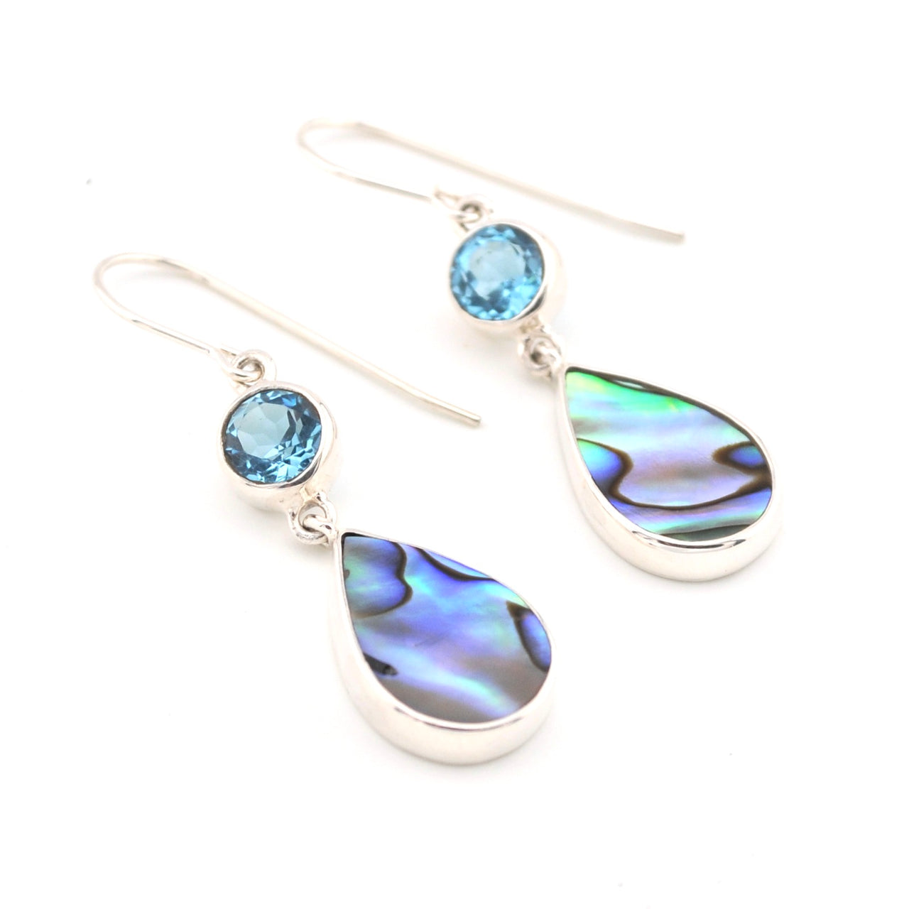 Teardrop-shaped earrings with abalone shell and blue gemstones on a white background