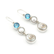 Silver earrings with pearls and blue gemstones on a white background