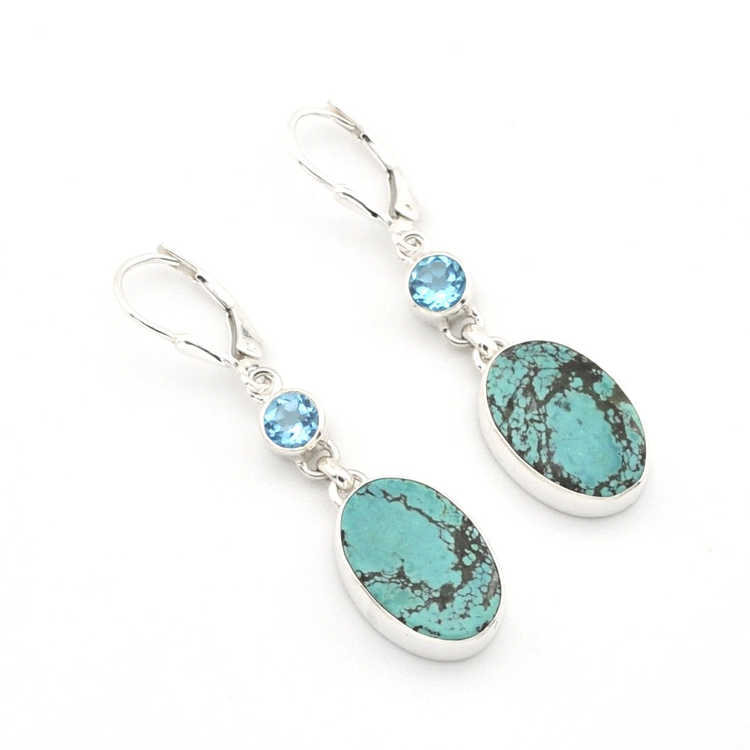 Turquoise and blue gemstone earrings on a white background