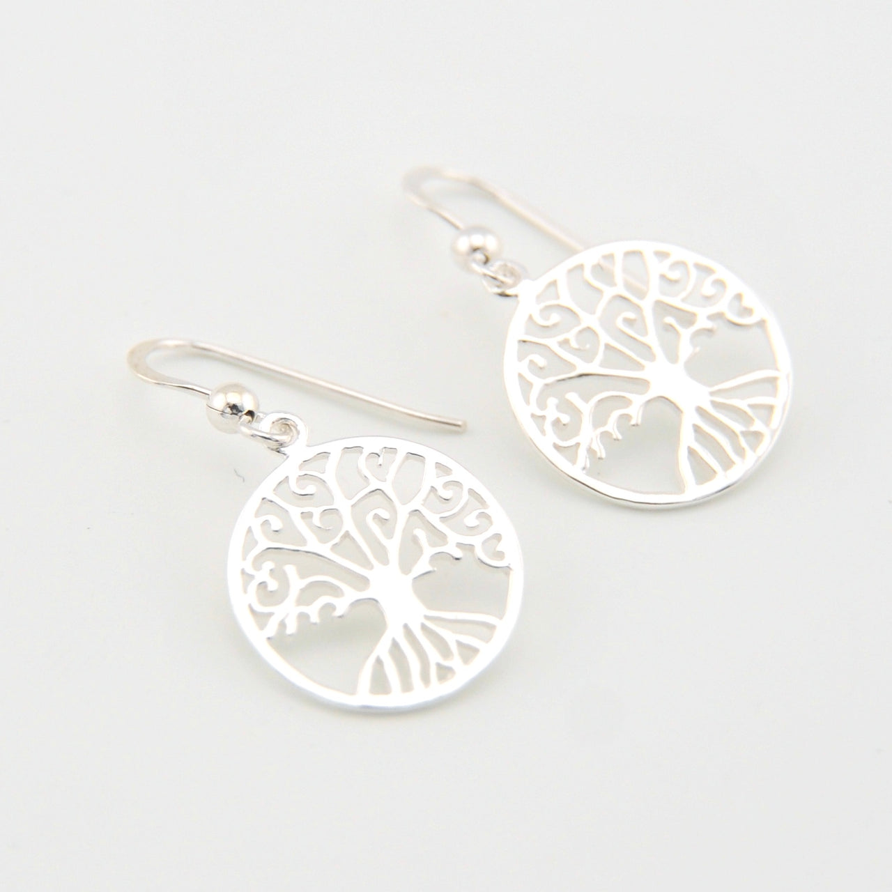 Silver tree of life earrings on a white background