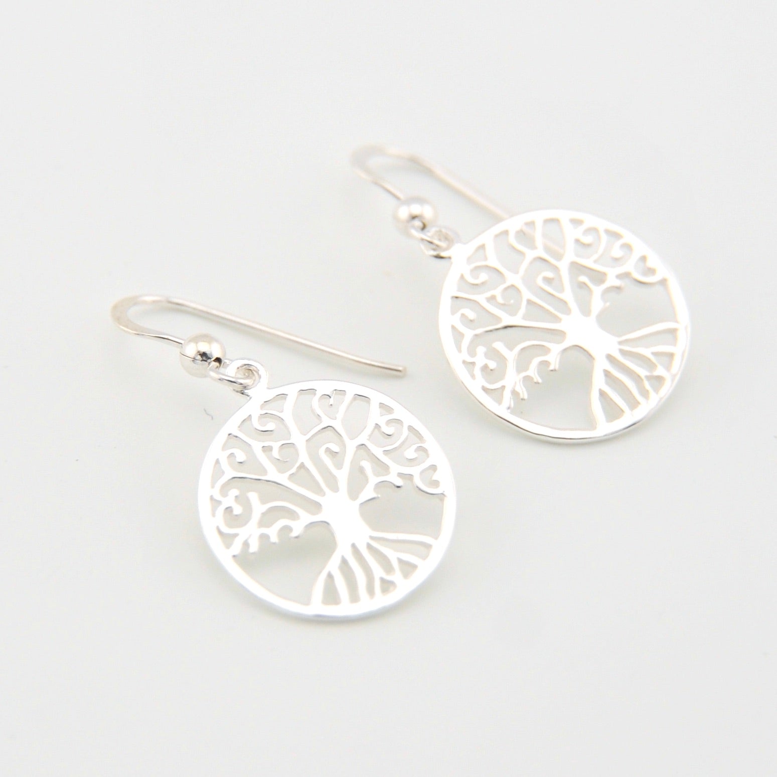Silver tree of life earrings on a white background