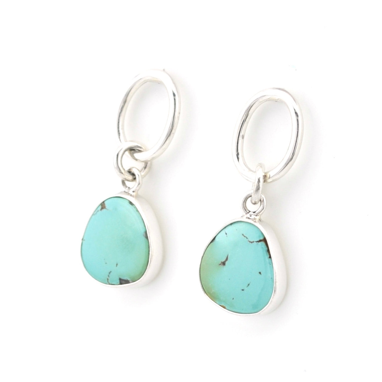 Turquoise teardrop earrings with silver hooks on a white background