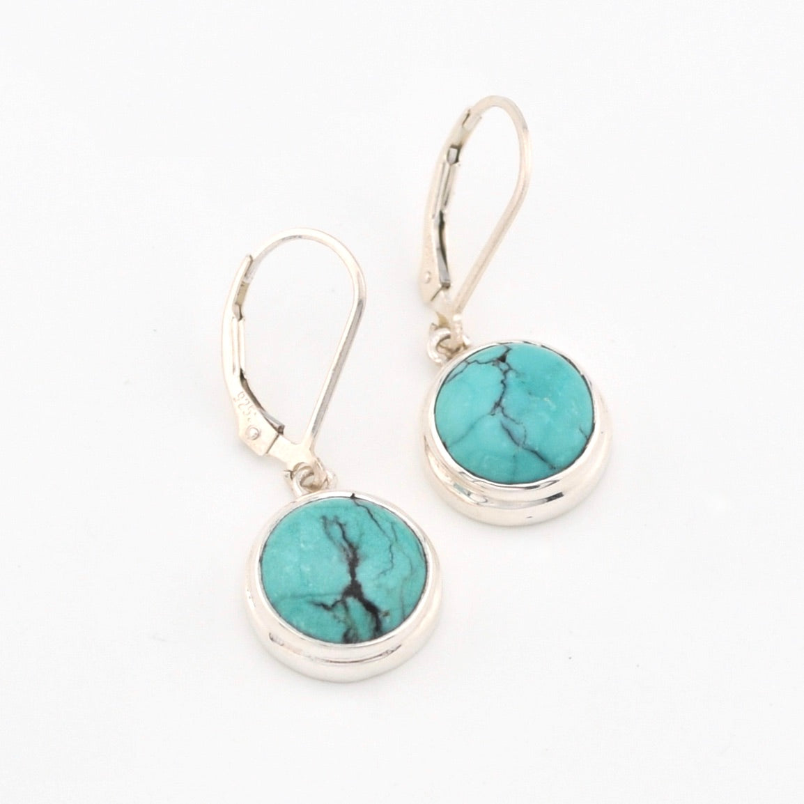 Turquoise stone earrings with silver hooks on a white background
