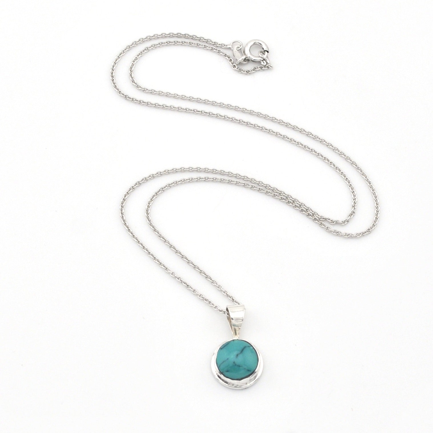 Silver necklace with a turquoise pendant on a white background