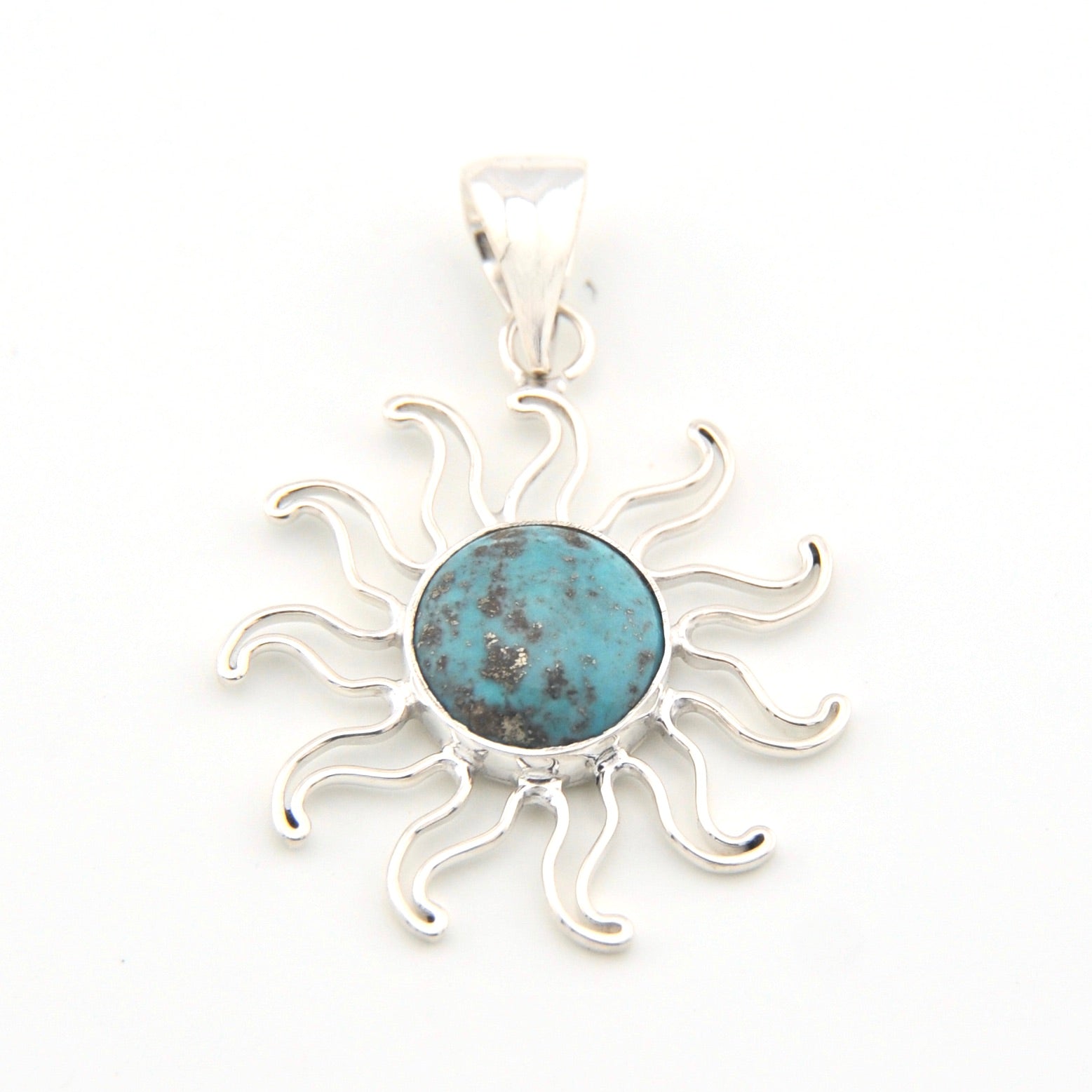 Silver sun-shaped pendant with a blue center on a white background