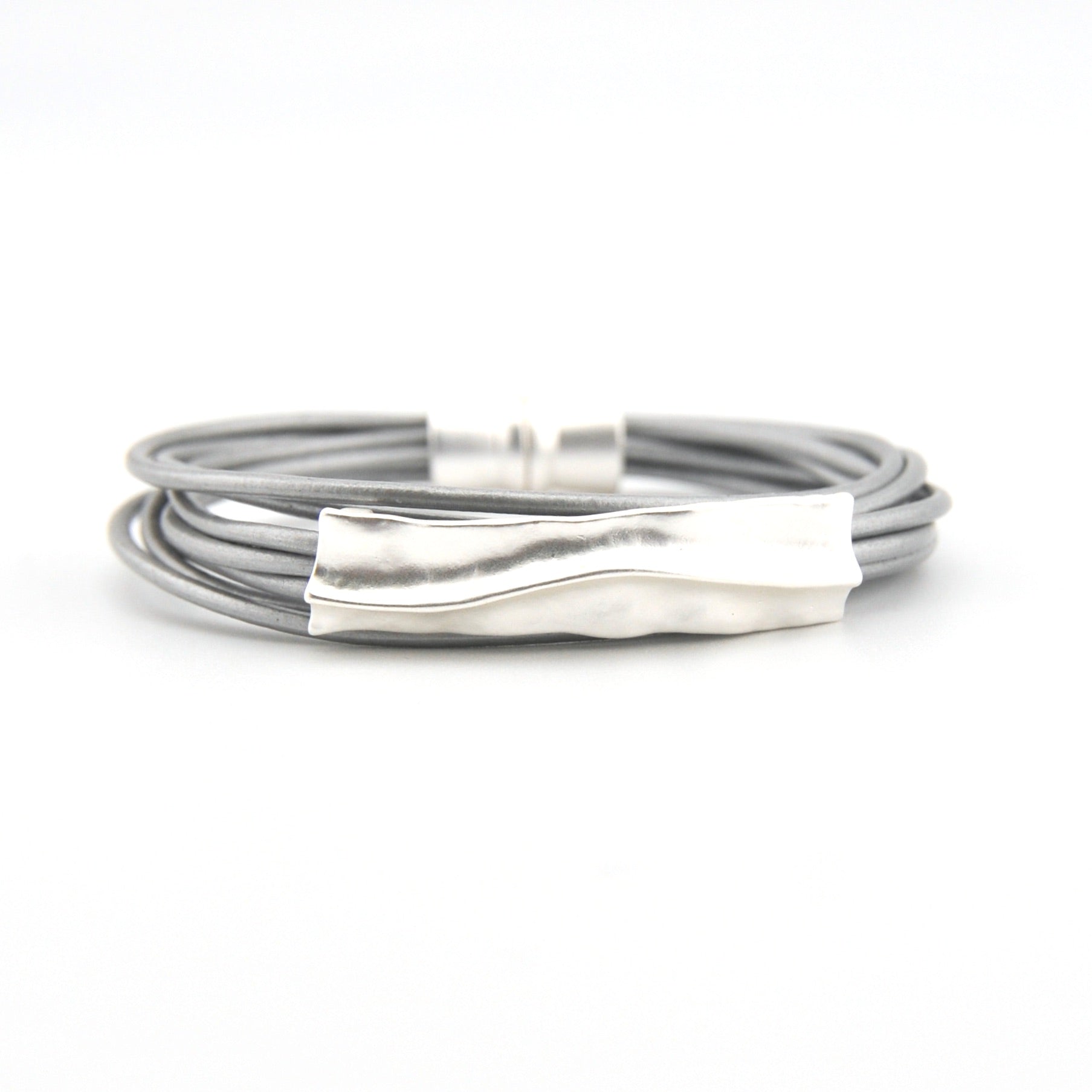 Silver bracelet with a textured clasp on a white background