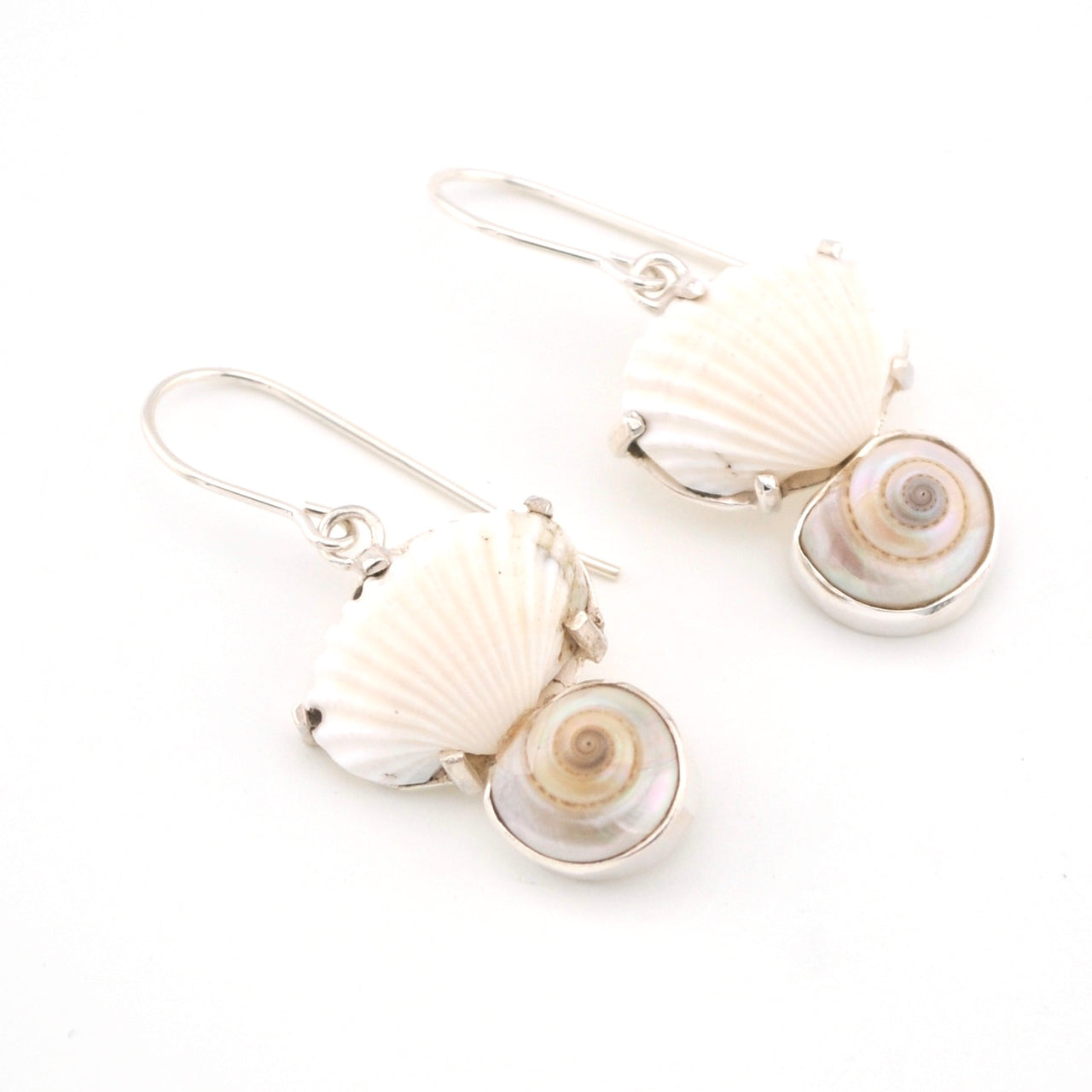 Shell-shaped earrings on a white background