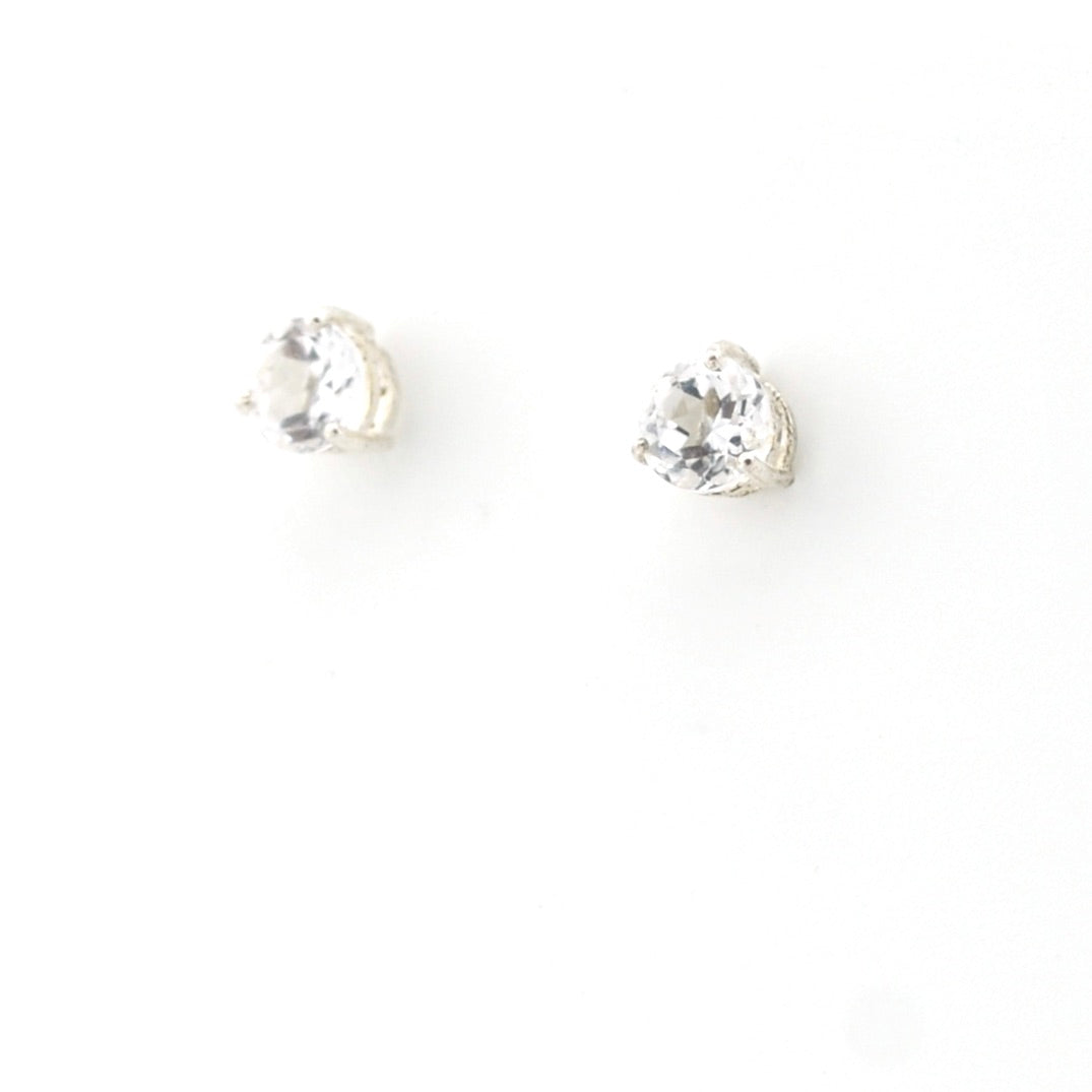 Pair of silver stud earrings with clear gemstones on a white background