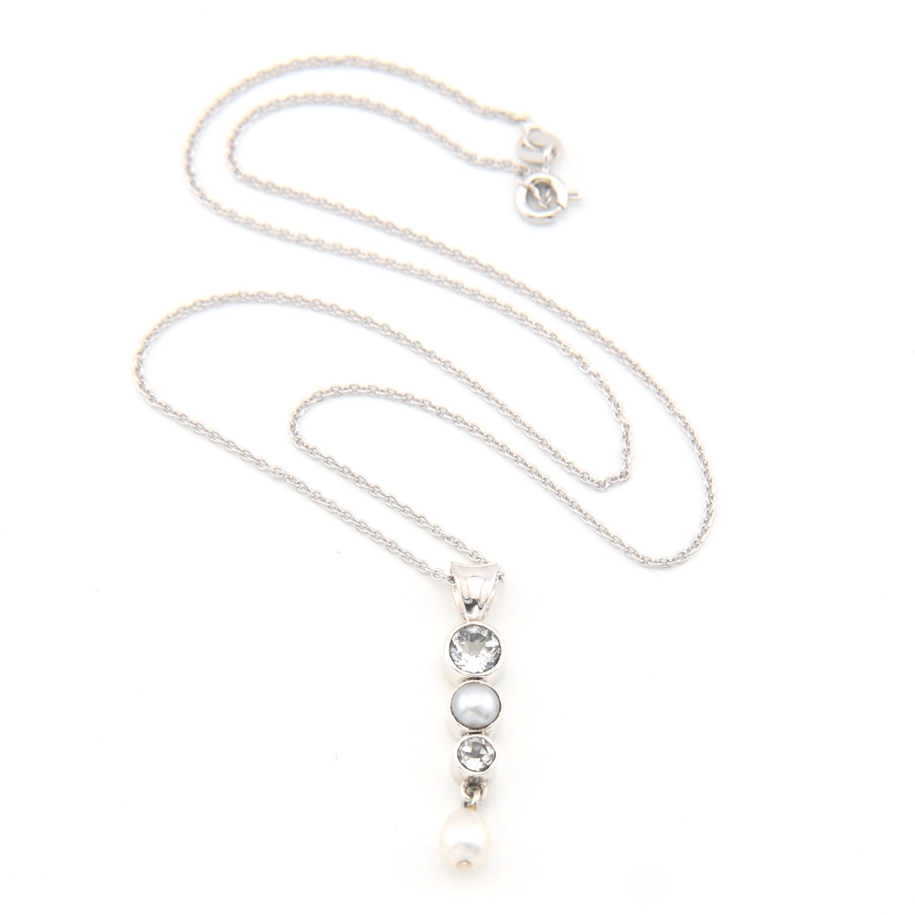 Necklace with a pendant featuring pearls and topaz on a white background