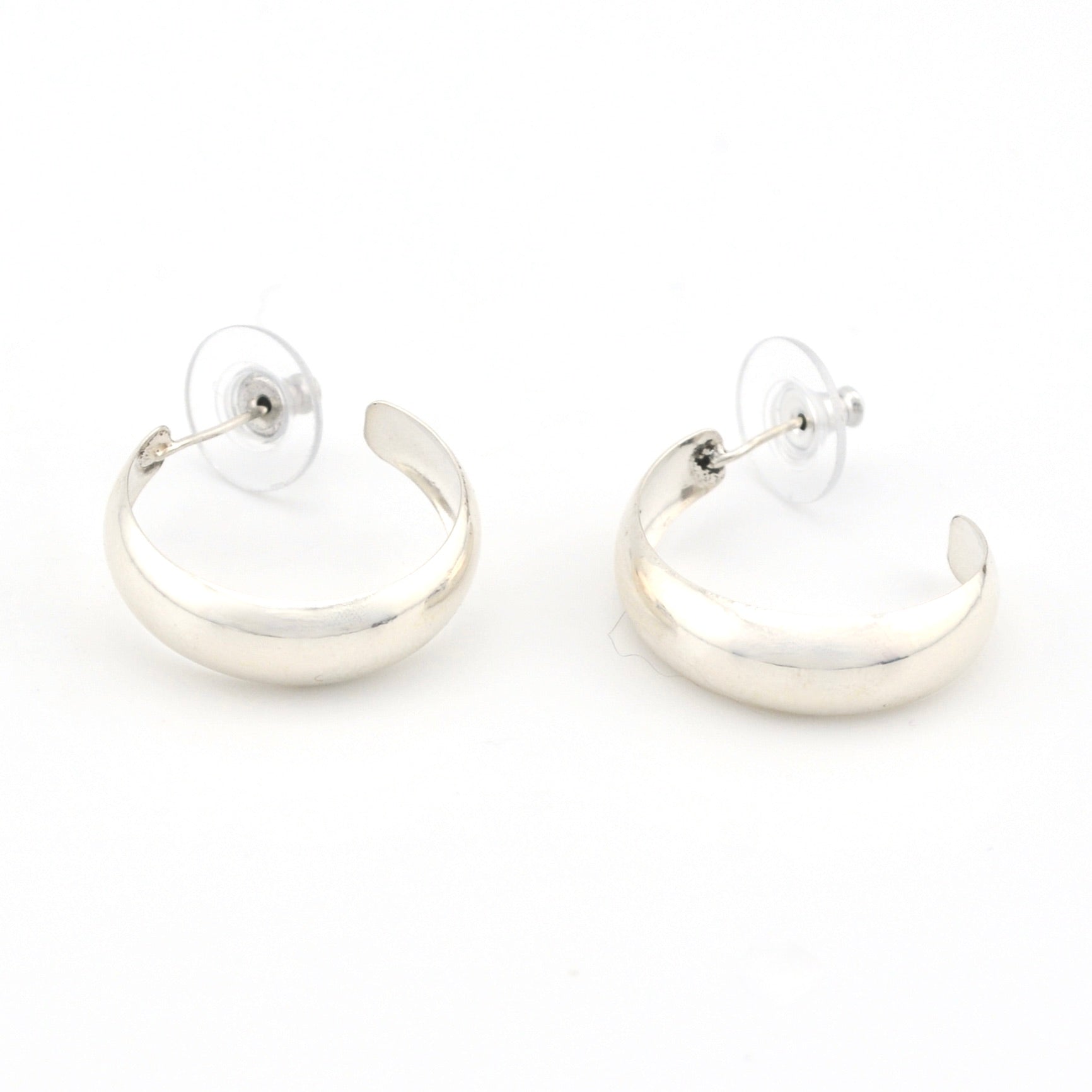 Pair of silver hoop earrings on a white background