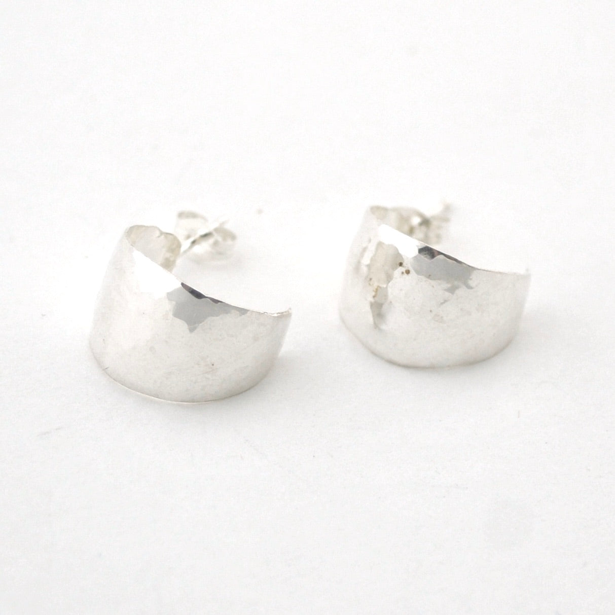 Pair of silver hoop earrings on a white background