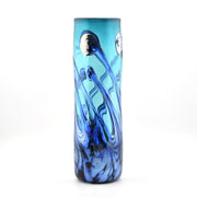 Blue glass vase with swirling patterns on a white background