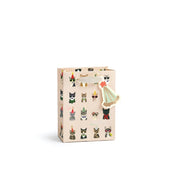 A beige gift bag decorated with a pattern of small illustrated cats in various outfits, featuring a decorative paper cat topper on the handle, set against a plain white background.