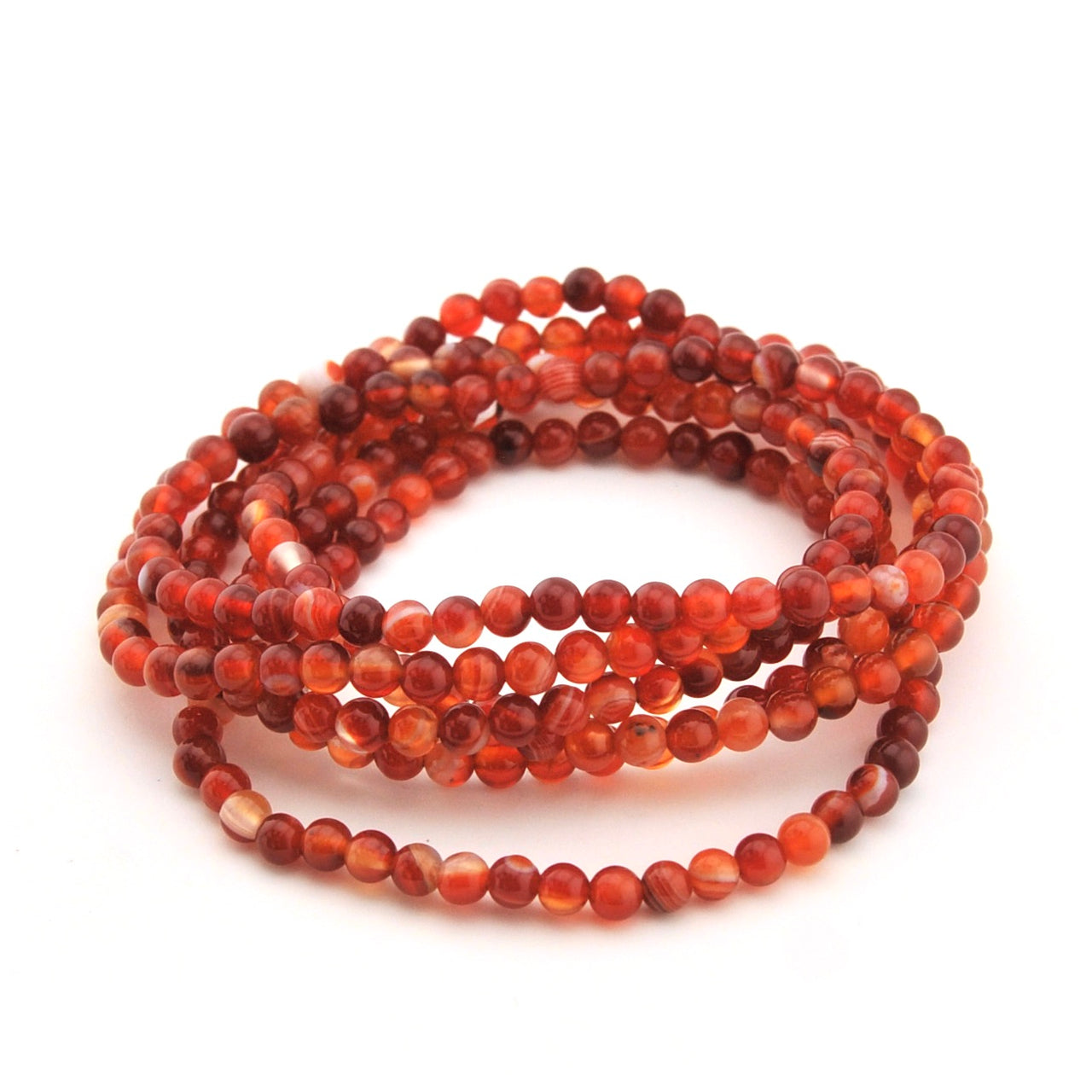 Stack of red and brown beaded bracelets on a white background