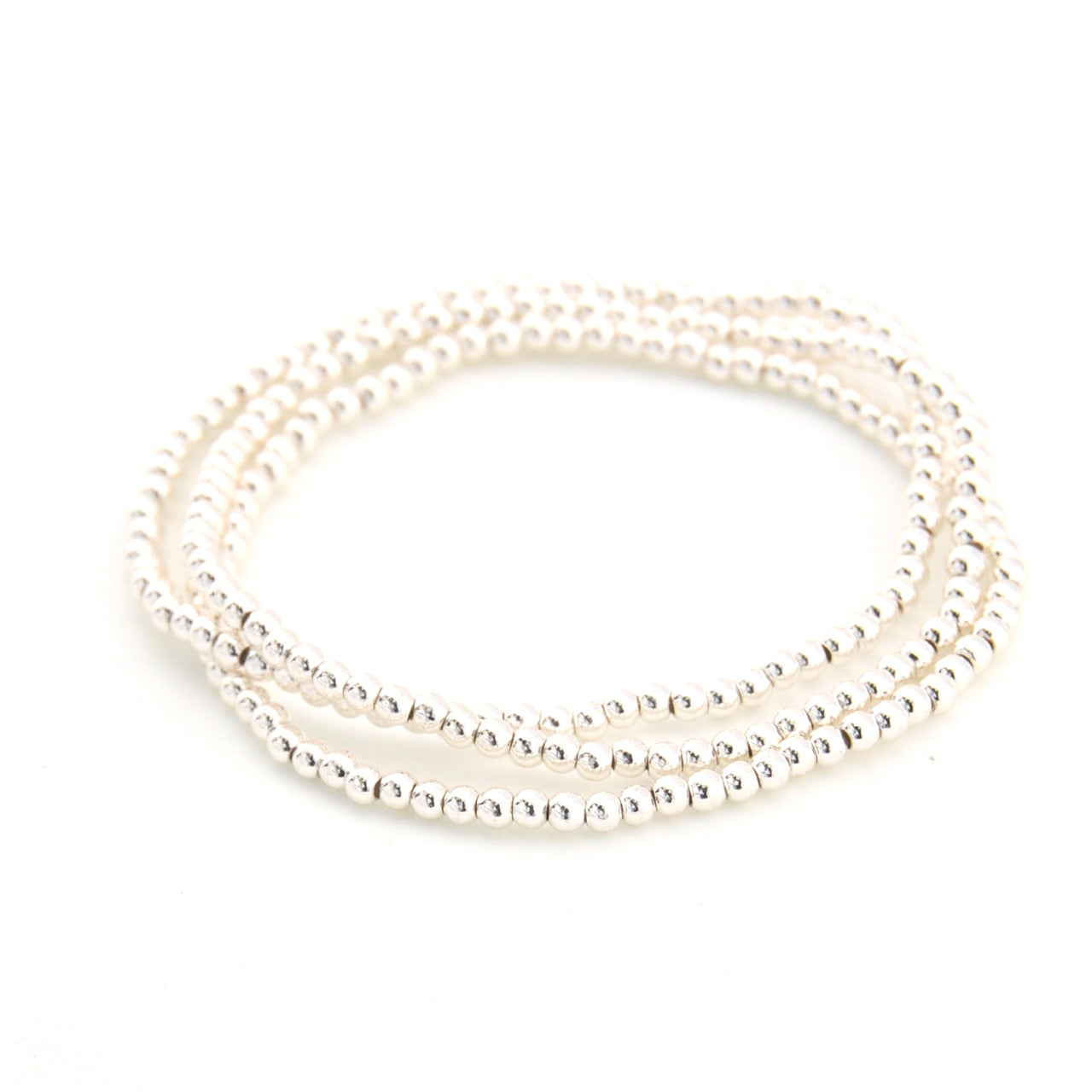Set of three pearl bracelets on a white background