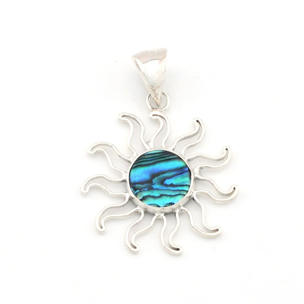 Silver sun-shaped pendant with a blue and green circular stone on a white background