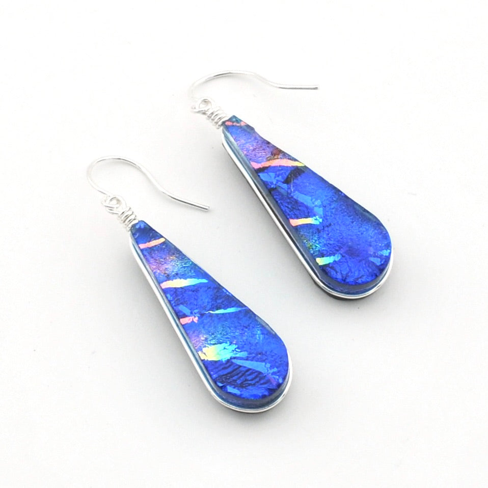 Dichroic Glass Rainbow Blue Tear Earrings on white background.