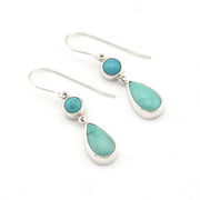 Turquoise teardrop earrings with silver hooks on a white background