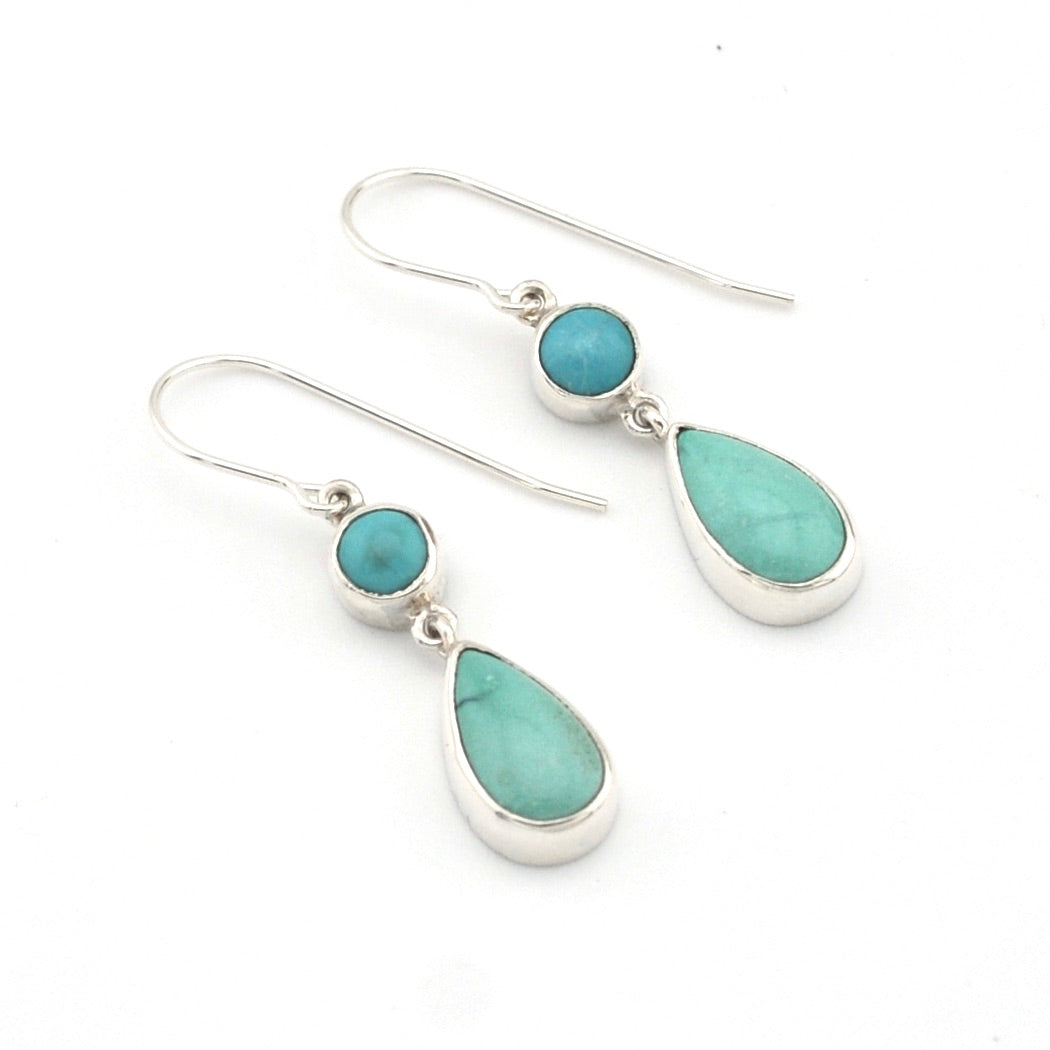 Turquoise teardrop earrings with silver hooks on a white background