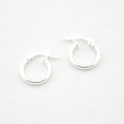 Pair of silver hoop earrings on a white background