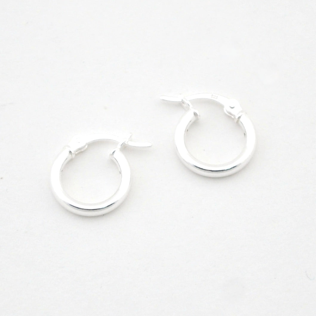 Pair of silver hoop earrings on a white background