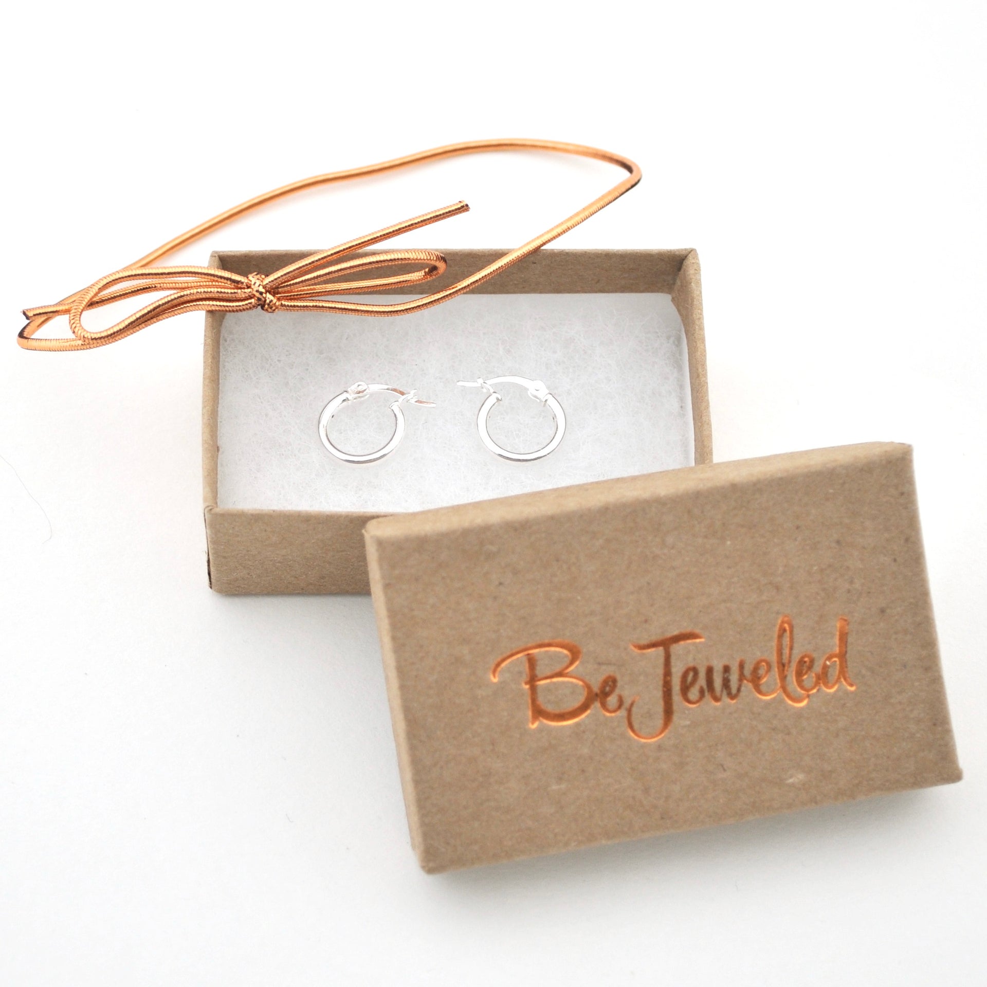 Silver hoop earrings in a 'Be Jeweled' box on a white background