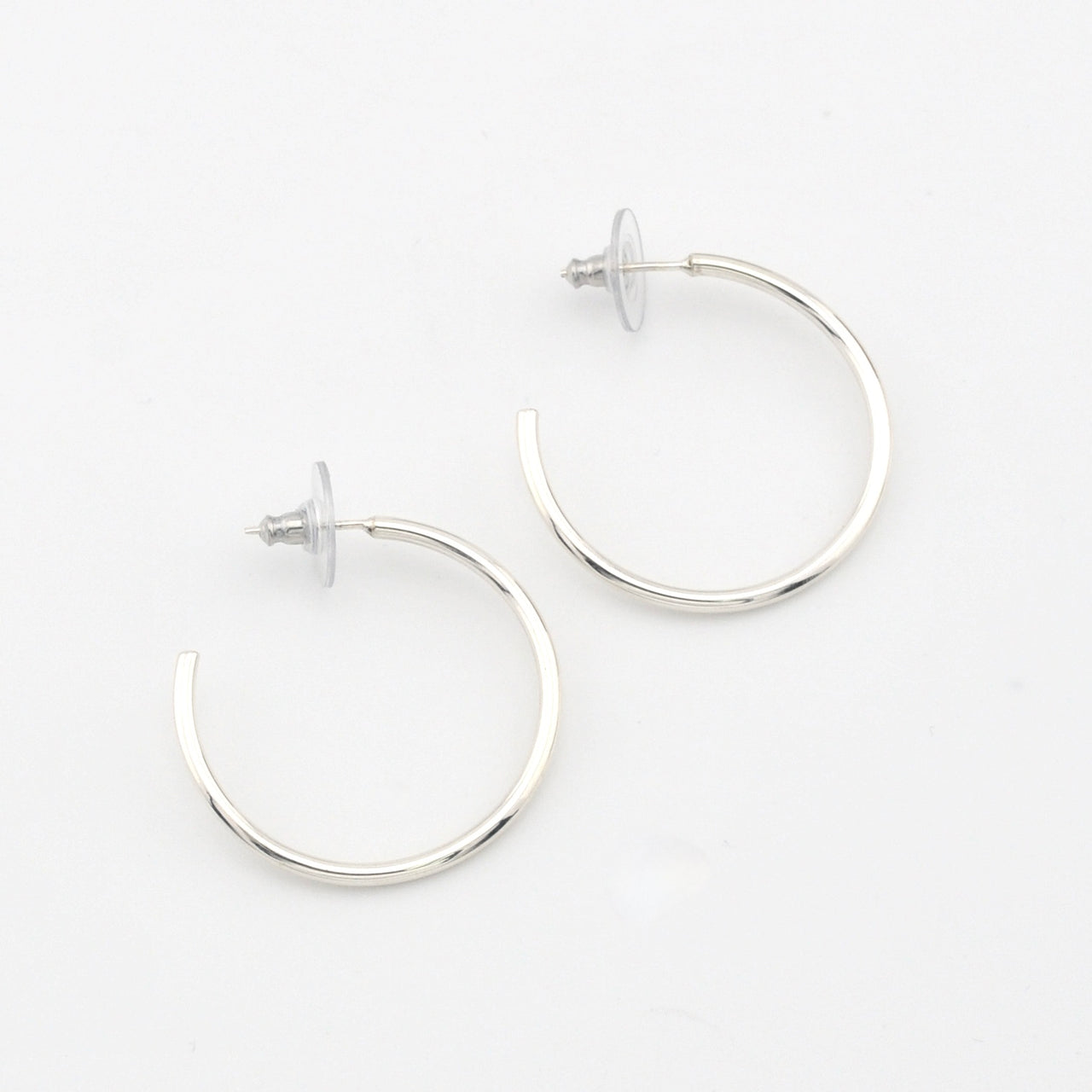 Silver hoop earrings on a white background