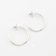 Silver hoop earrings on a white background