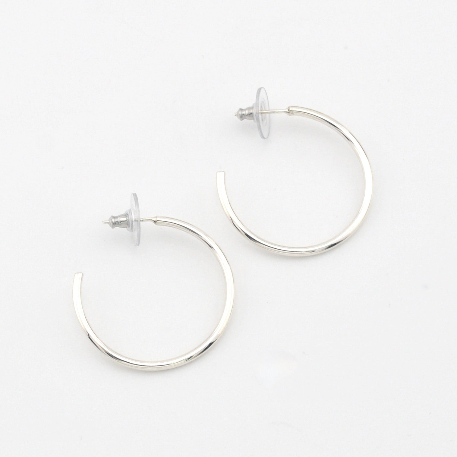 Silver hoop earrings on a white background