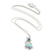 A silver-toned turtle pendant necklace featuring iridescent blue-green abalone shell inlays on the turtles' shells, displayed on a clean white background.