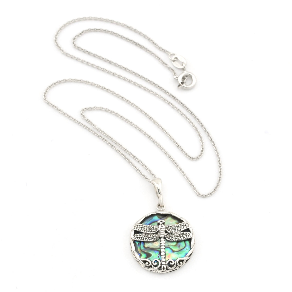 A silver dragonfly pendant necklace featuring a detailed silver dragonfly over an iridescent green and blue abalone shell background, displayed on a clean white background.