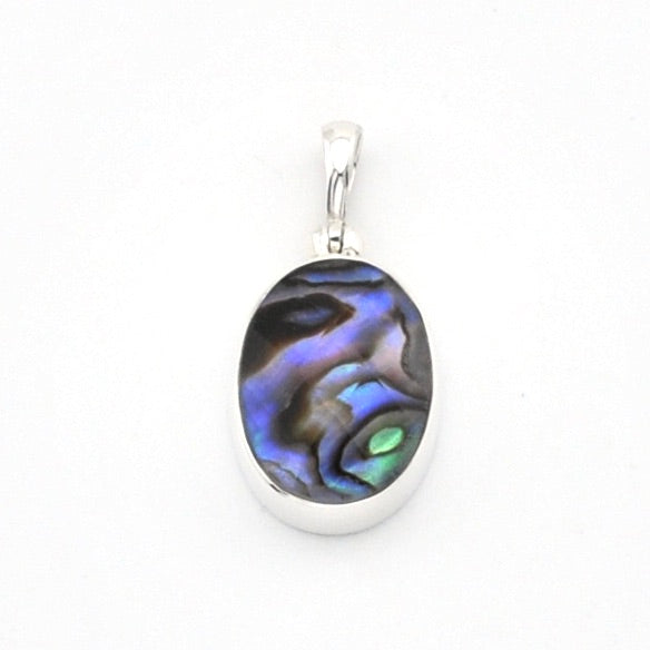 An oval pendant featuring a polished iridescent abalone shell inlay with blue, purple, green, and black swirls, set in a silver-toned metal bezel with a silver bail, shown on a plain white background.
