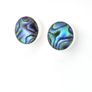A pair of round stud earrings with iridescent abalone shell inlays on a white background.