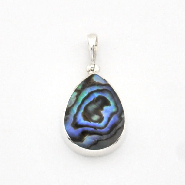 A teardrop-shaped pendant featuring a polished iridescent abalone shell inlay with blue, green, and black swirls, set in a silver-toned metal bezel with a silver bail, shown on a plain white background.
