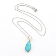 A silver teardrop pendant necklace featuring a light turquoise blue stone, displayed on a clean white background.