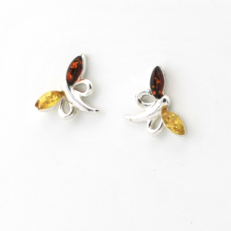 A pair of silver butterfly stud earrings featuring marquise-cut amber brown top stones and yellow bottom stones, set against a plain white background.