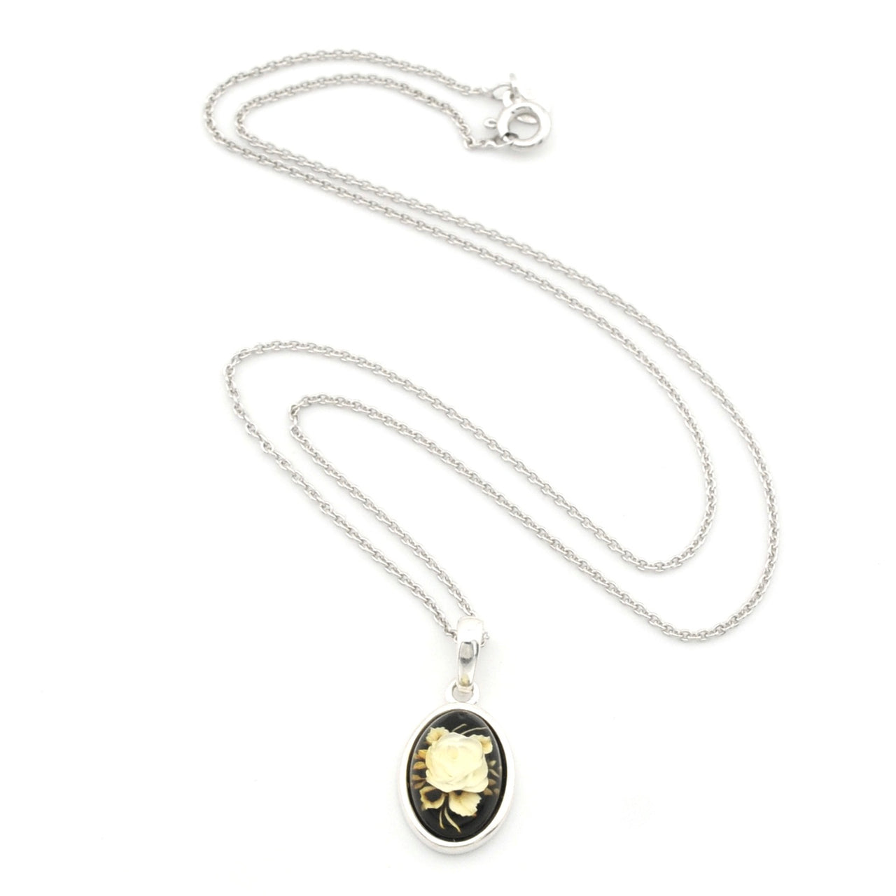 A silver chain necklace with an oval pendant featuring a black background and a vintage-style illustration of a yellow flower in a silver frame, displayed on a clean white background.