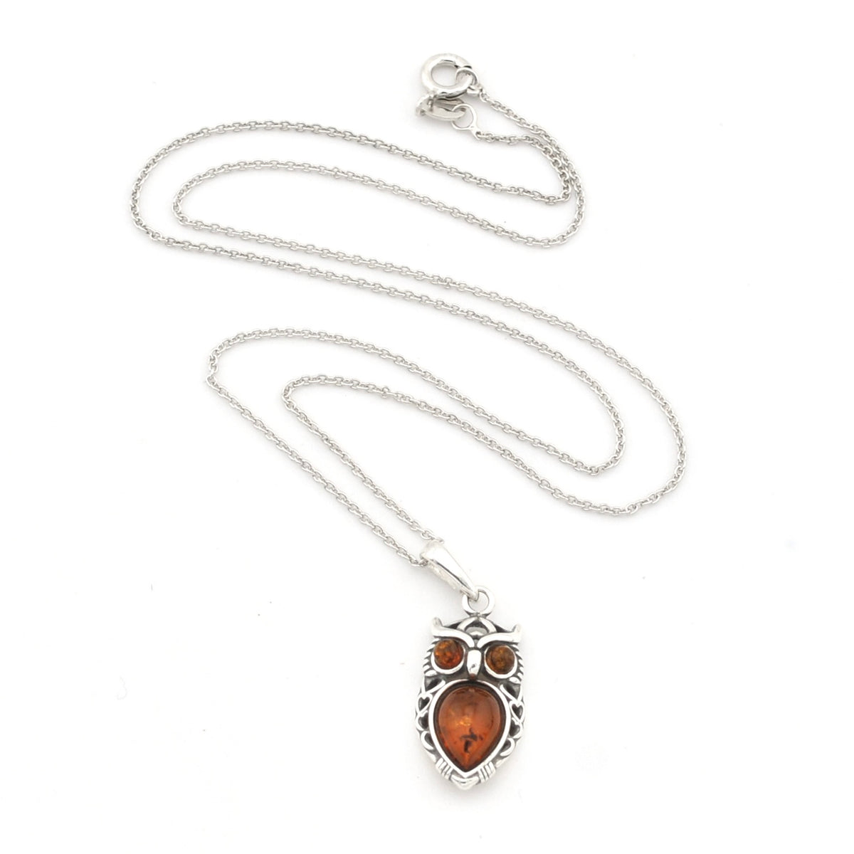 A silver owl pendant necklace featuring a polished amber-orange center stone and two smaller amber stones for eyes, displayed on a clean white background.