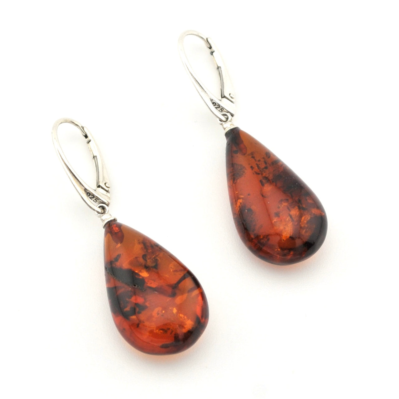 A pair of teardrop-shaped amber drop earrings with silver leverback hooks, displayed on a clean white background.