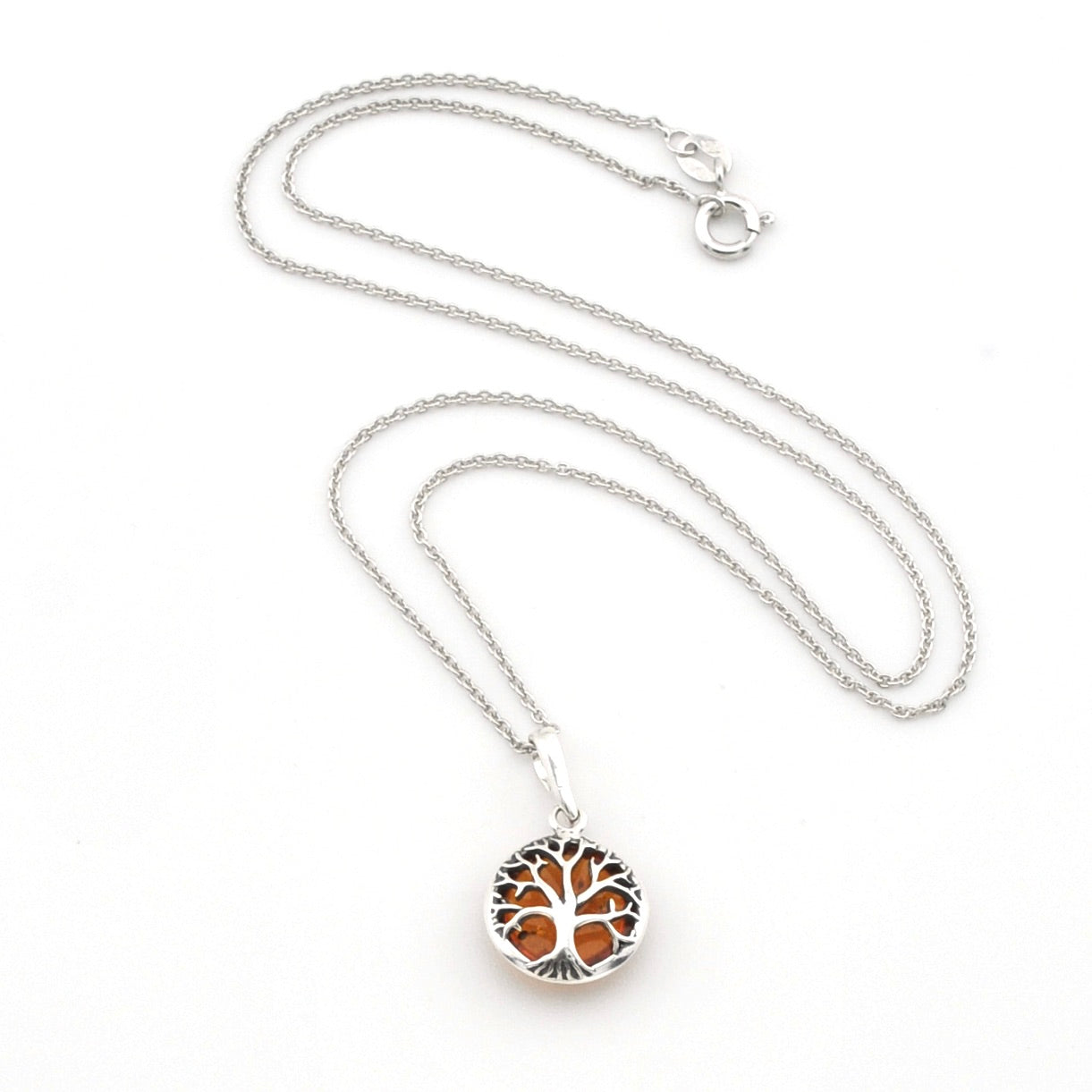 A silver tree of life pendant necklace with amber-colored inlay, displayed on a clean white background.