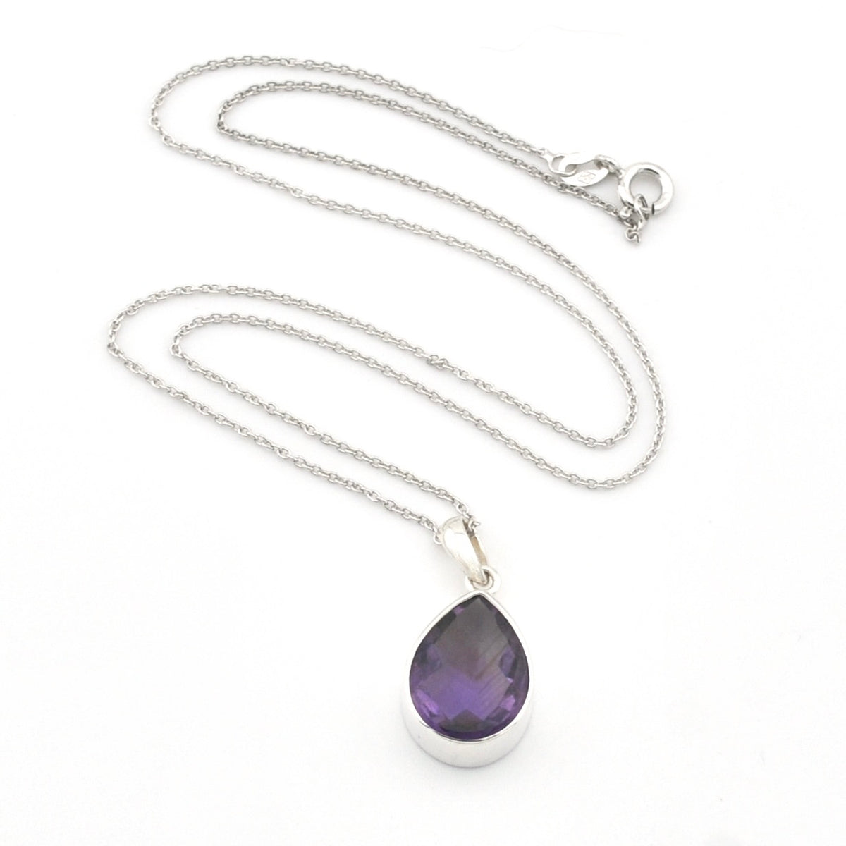 A silver teardrop pendant necklace featuring a faceted purple gemstone, displayed on a clean white background.