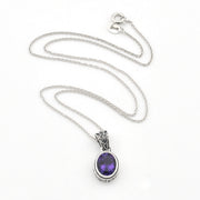 A silver chain necklace with an oval purple gemstone pendant, displayed on a clean white background.