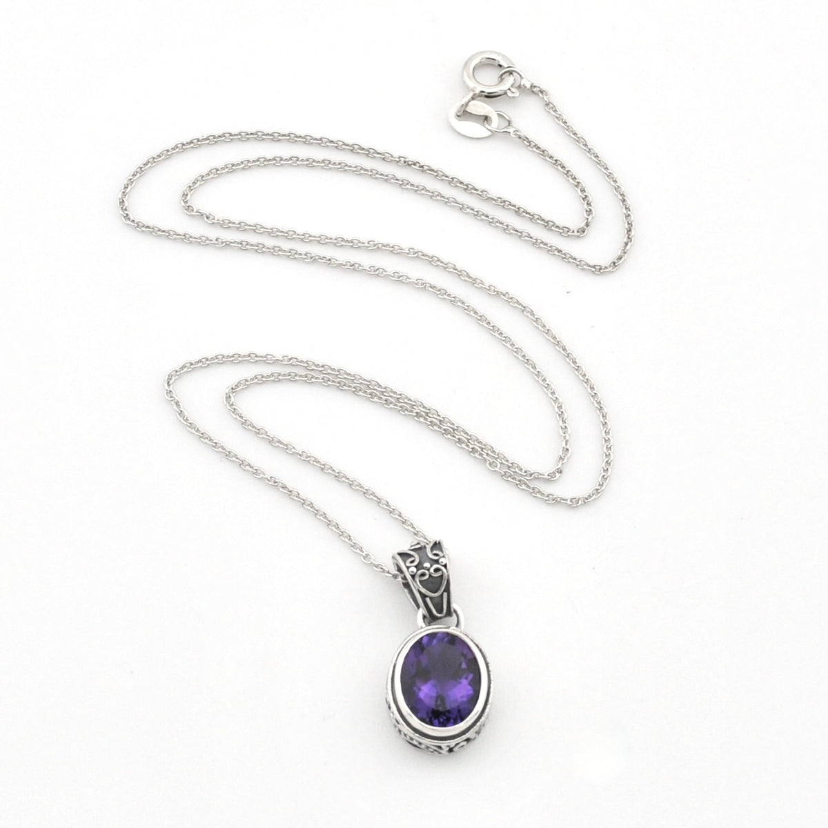 A silver chain necklace with an oval purple gemstone pendant, displayed on a clean white background.