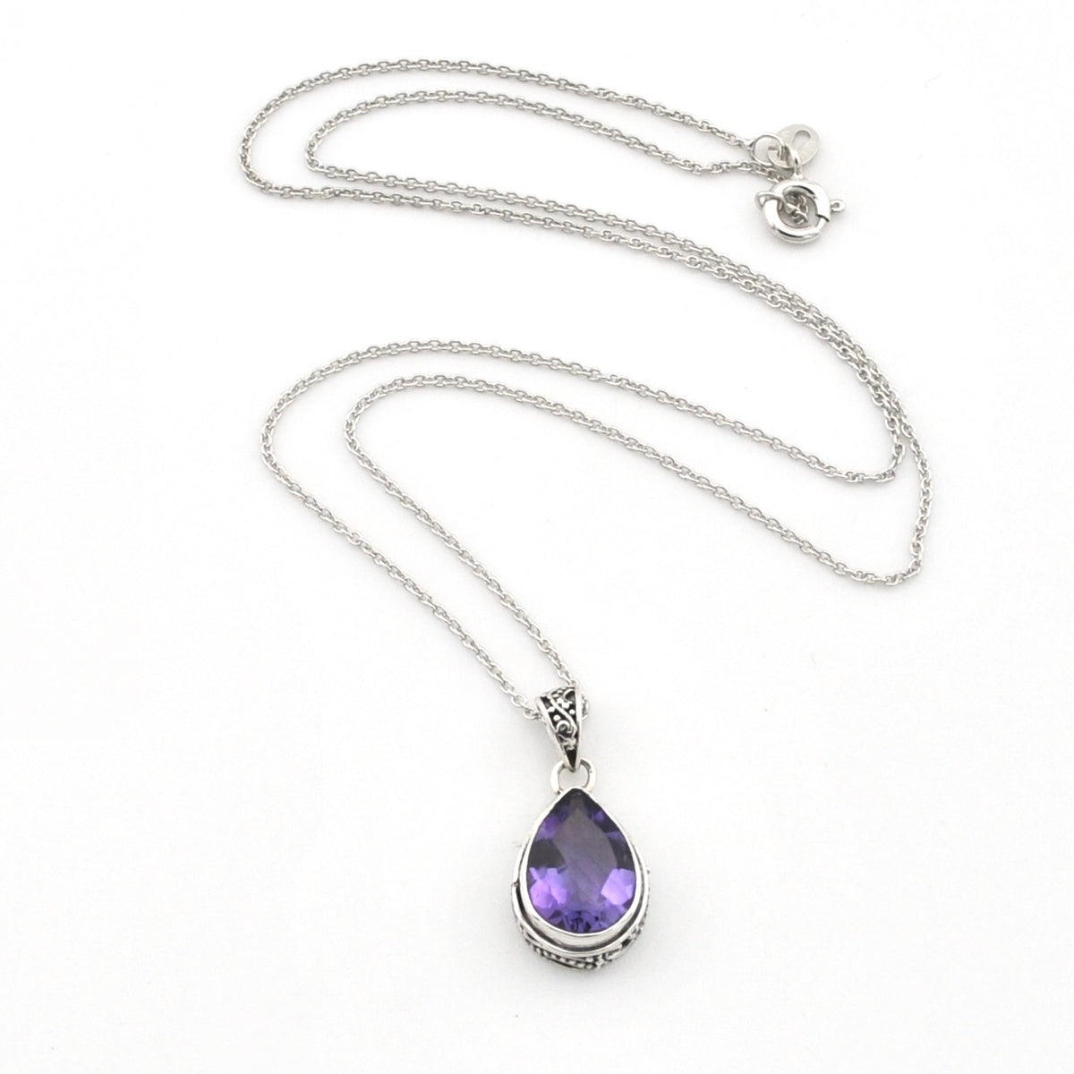A silver chain necklace with a teardrop-shaped purple gemstone pendant, displayed on a clean white background.