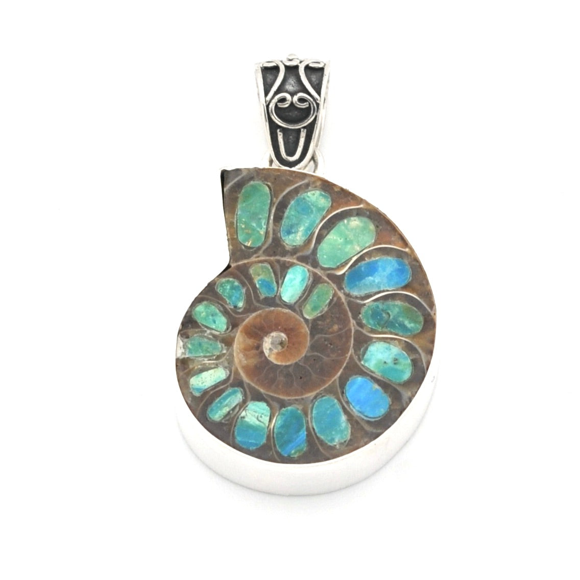 A round silver pendant featuring a spiral ammonite fossil inlay with blue opal, shown on a plain white background.