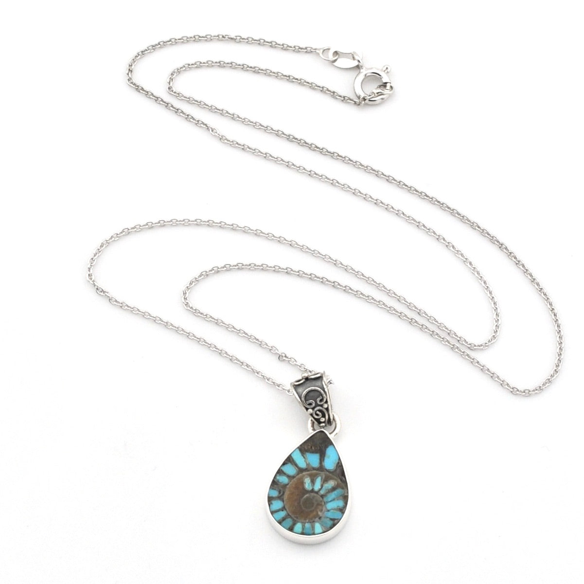 A silver chain necklace with a teardrop-shaped pendant featuring a turquoise and brown spiral pattern, displayed on a clean white background.