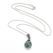 A silver chain necklace with a teardrop-shaped pendant featuring a turquoise and brown spiral pattern, displayed on a clean white background.