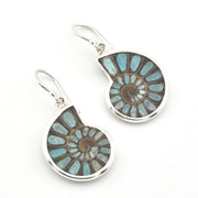 A pair of silver leverback earrings featuring spiral ammonite shell inlays with light blue and brown natural stone patterns, shown on a plain white background.