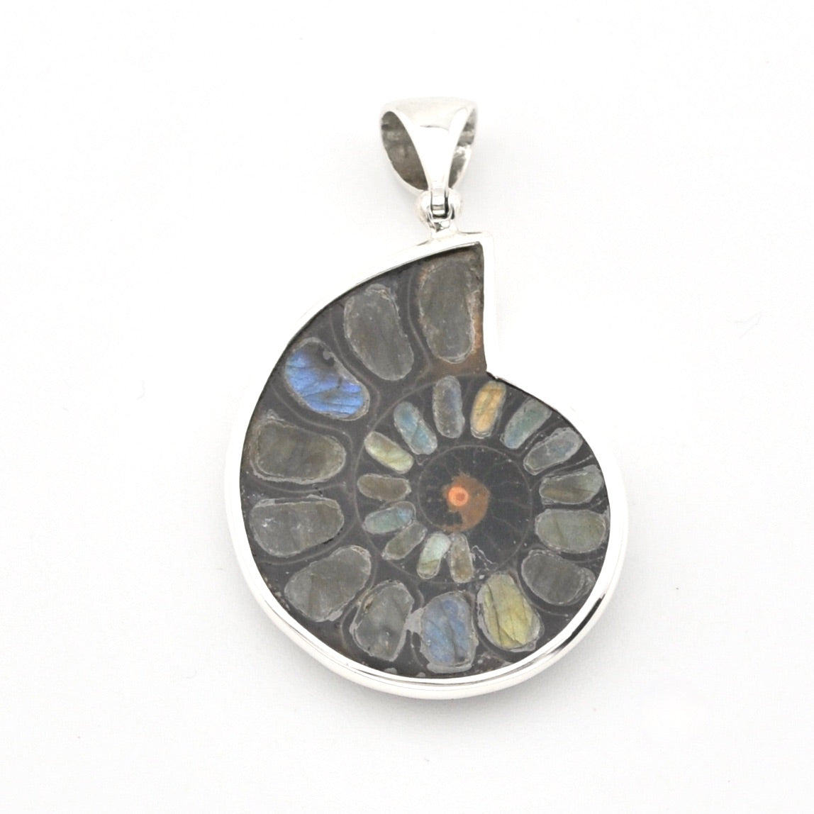 A teardrop-shaped silver pendant featuring a polished mosaic of natural ammolite stones in shades of gray, blue, green, and a small orange center, suspended on a white background.